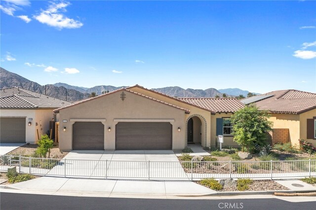 mediterranean / spanish house featuring a garage and a mountain view