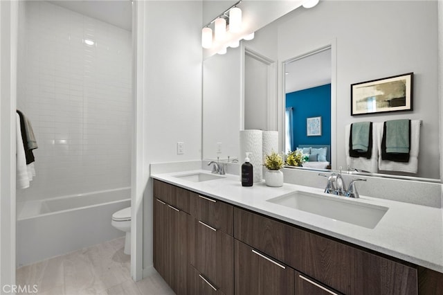 full bathroom featuring toilet, vanity, and shower / bathing tub combination