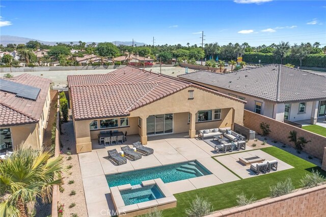 view of swimming pool featuring an in ground hot tub, a patio area, exterior bar, and an outdoor living space