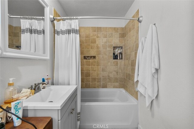 bathroom featuring vanity and shower / tub combo with curtain