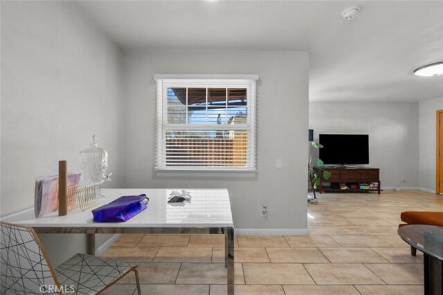 dining space featuring light tile patterned floors