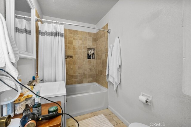 full bathroom featuring toilet, shower / bath combo, sink, and tile patterned floors