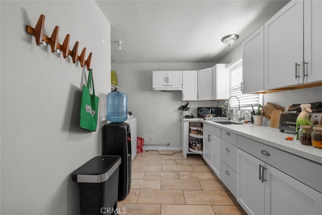 kitchen featuring sink and white cabinets