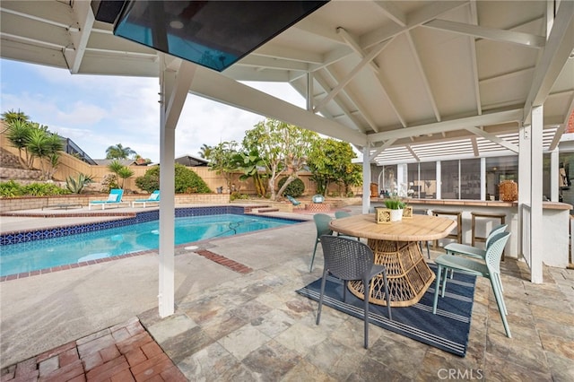 view of pool featuring a patio area and exterior bar