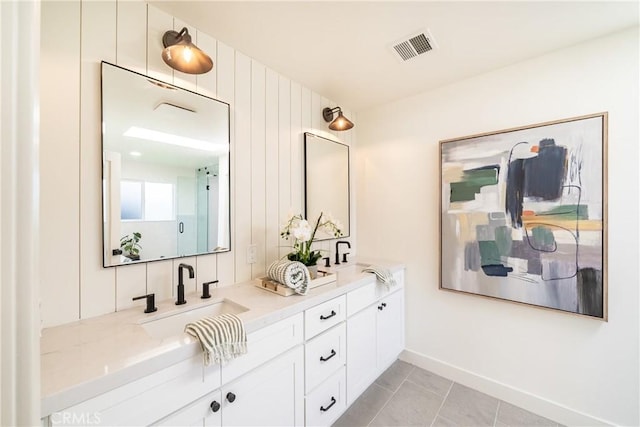 bathroom with tile patterned floors and vanity