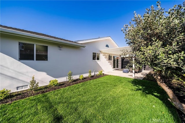 back of property with a lawn, a pergola, and a patio