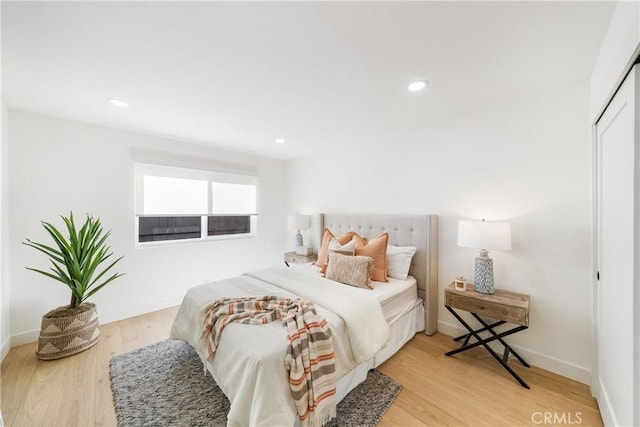 bedroom featuring a closet and light hardwood / wood-style flooring