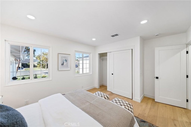 bedroom featuring a closet and light hardwood / wood-style flooring