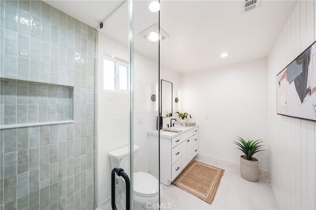 bathroom featuring toilet, tile patterned flooring, a shower, and vanity