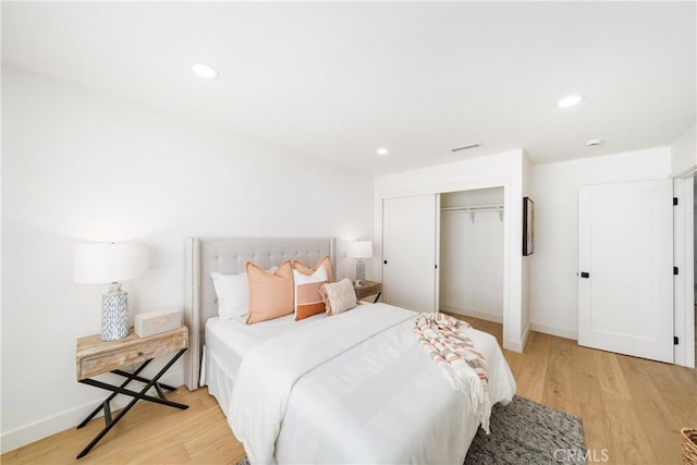 bedroom featuring a closet and light hardwood / wood-style flooring