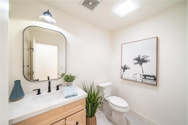 bathroom with toilet and vanity