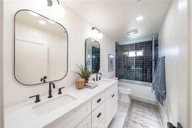 full bathroom with toilet, vanity, tiled shower / bath, and tile patterned flooring