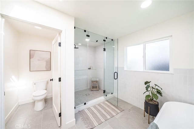 bathroom with toilet, tile patterned flooring, and independent shower and bath