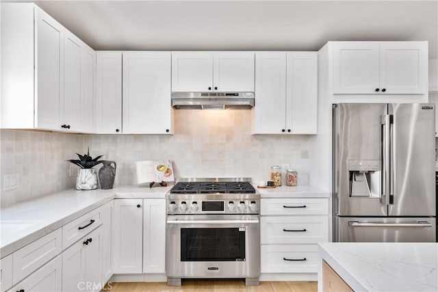 kitchen featuring decorative backsplash, stainless steel appliances, and white cabinetry