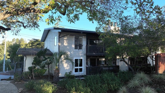 back of house featuring a balcony