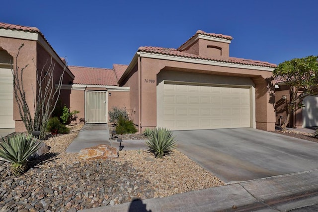 mediterranean / spanish home featuring a garage