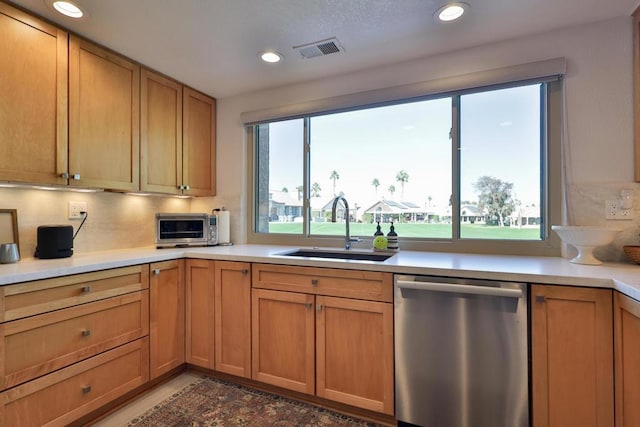 kitchen featuring sink, dishwasher, plenty of natural light, and tasteful backsplash