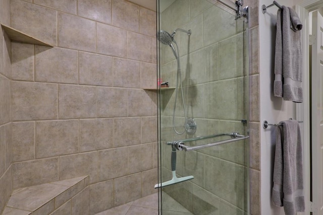 bathroom featuring a shower with shower door