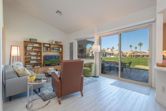 living room with lofted ceiling and light hardwood / wood-style floors