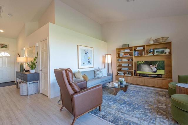 living room with vaulted ceiling and light hardwood / wood-style floors