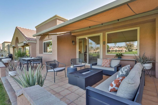 view of patio / terrace with an outdoor living space with a fire pit