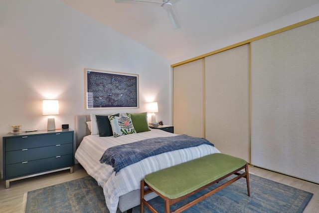 bedroom with ceiling fan, a closet, dark hardwood / wood-style flooring, and vaulted ceiling