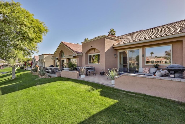 rear view of house featuring outdoor lounge area, a yard, and a patio