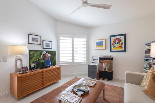 living room with ceiling fan and vaulted ceiling