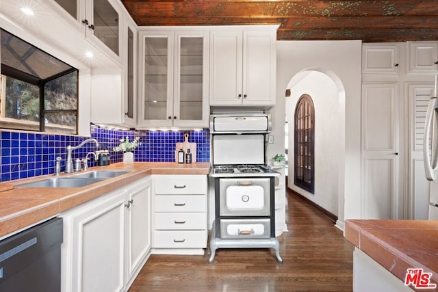 kitchen featuring decorative backsplash, sink, beamed ceiling, black dishwasher, and white cabinets