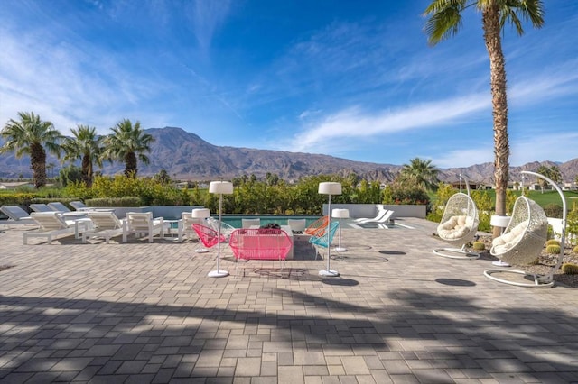 exterior space with a mountain view and a patio area