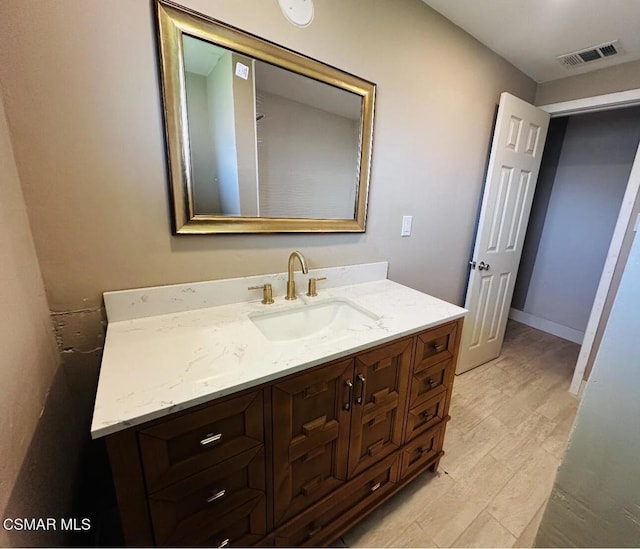 bathroom with hardwood / wood-style flooring and vanity