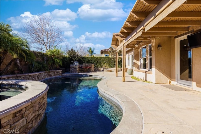 view of swimming pool with a patio area and an in ground hot tub