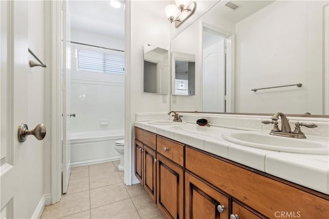 full bathroom with tub / shower combination, tile patterned floors, toilet, and vanity