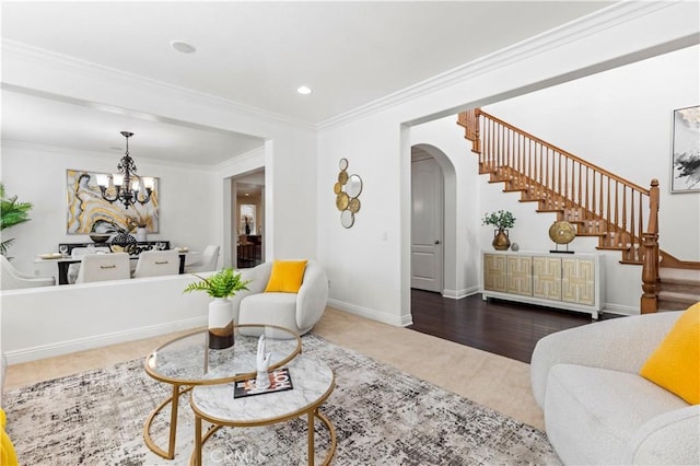 living room with hardwood / wood-style floors, crown molding, and a chandelier