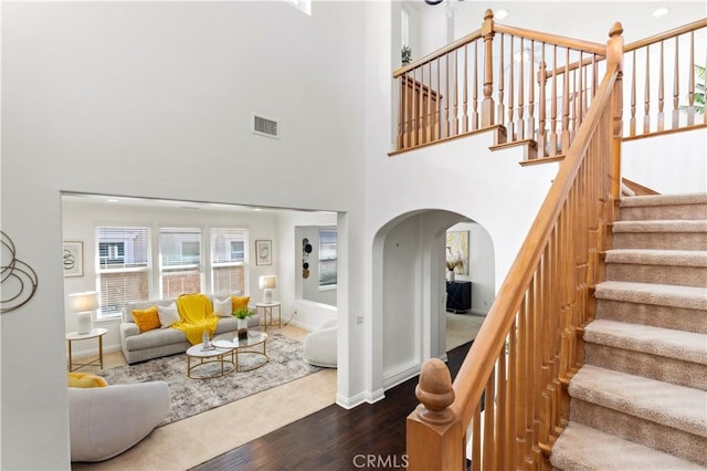 living room with dark hardwood / wood-style flooring and a high ceiling