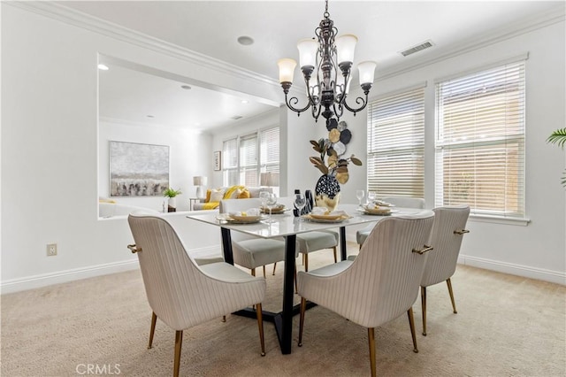 carpeted dining area with ornamental molding and a chandelier