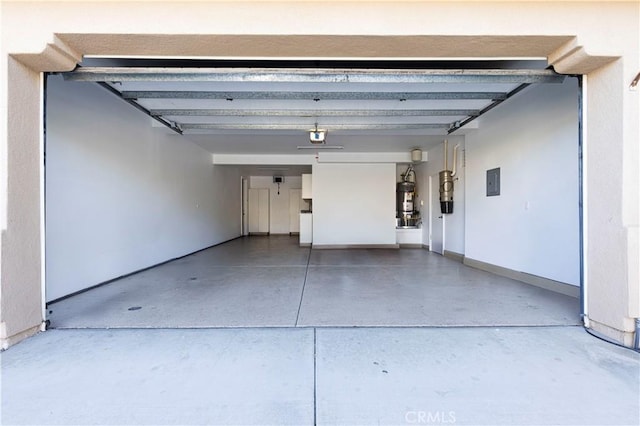 garage featuring electric panel, strapped water heater, and a garage door opener