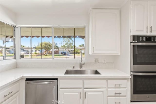 kitchen with sink, white cabinetry, and appliances with stainless steel finishes