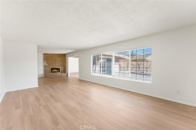 unfurnished living room with light hardwood / wood-style flooring and a fireplace