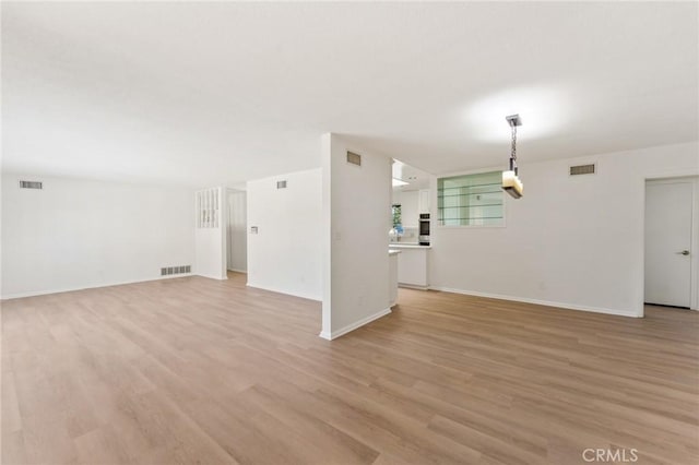 unfurnished living room featuring light hardwood / wood-style flooring