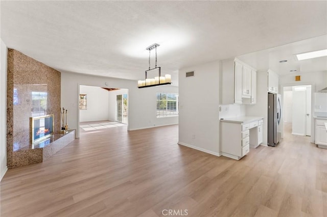 interior space with a fireplace and light hardwood / wood-style flooring