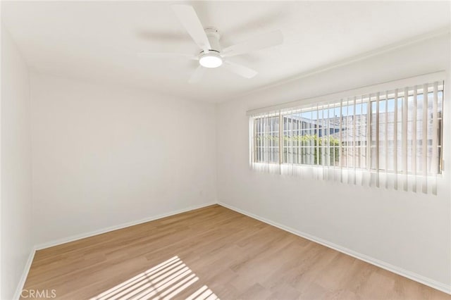 spare room featuring ceiling fan and light wood-type flooring