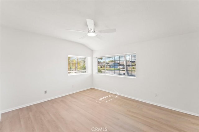 unfurnished room featuring light hardwood / wood-style floors, lofted ceiling, and ceiling fan