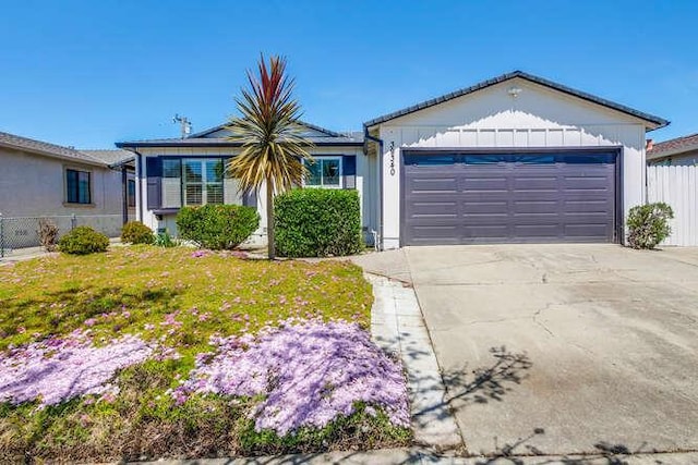 single story home with a garage and a front yard