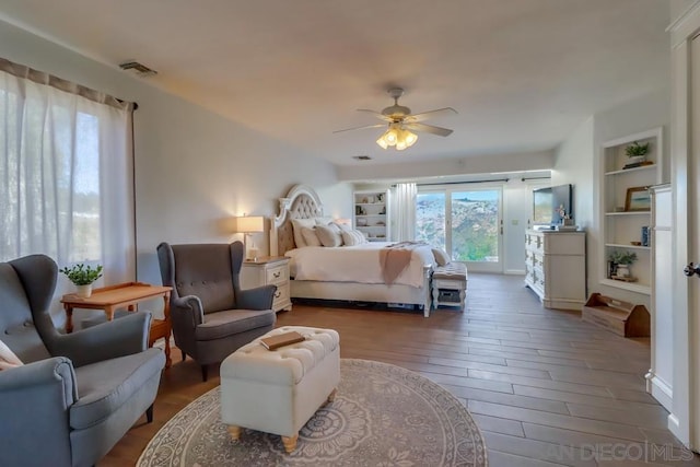 bedroom with ceiling fan, multiple windows, dark hardwood / wood-style floors, and access to outside