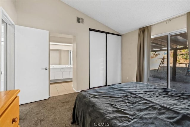 carpeted bedroom with access to outside, a closet, and lofted ceiling