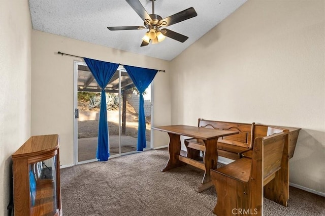 dining space featuring a textured ceiling, ceiling fan, carpet, and lofted ceiling