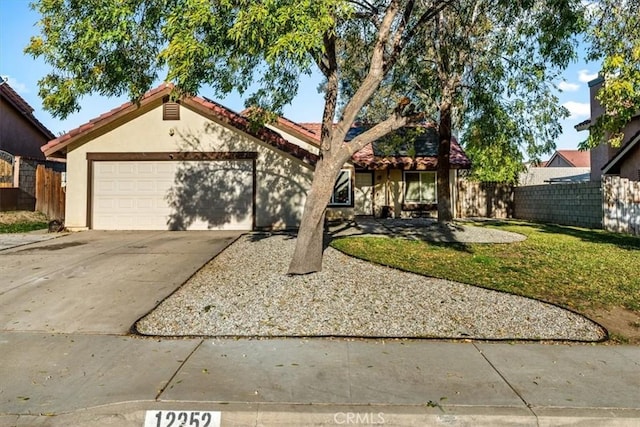 view of front of house with a garage and a front yard