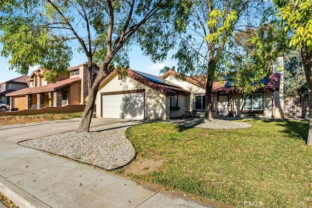 view of front of house featuring a garage and a front yard