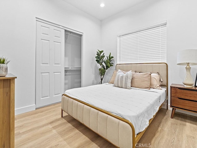 bedroom featuring light wood-type flooring and a closet